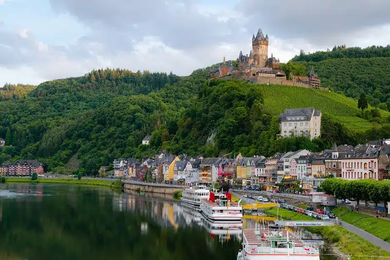 a city on a hill with boats on the water with our Affordable and Budget Europe Tour Packages