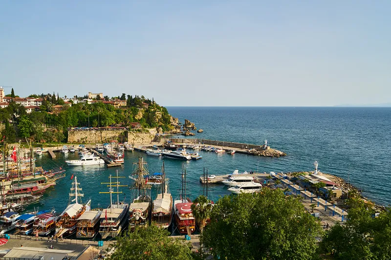 Enjoy a a harbor with boats and buildings on the side with our deluxe Turkey holiday