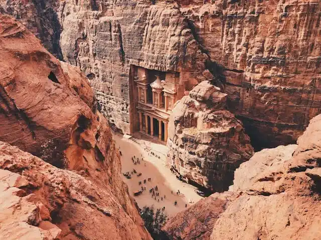 Tourists Standing in Front of Historical Monument While a Visit to Jordan