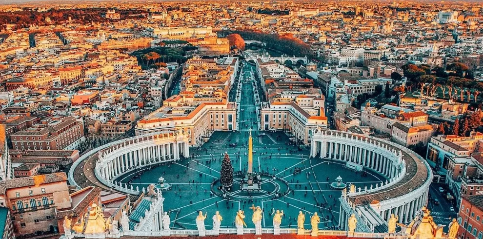 Aerial view of Rome showcasing its historic architecture and vibrant cityscape under a clear blue sky in our Italy itinerary Days