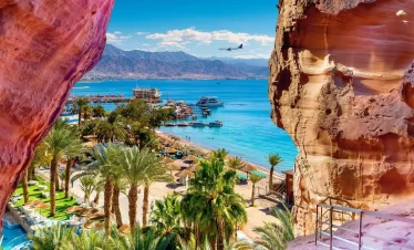 Aqaba and A panoramic view from a rocky outcrop surrounded by vast ocean waters under a clear blue sky in our Jordan itinerary 10 days