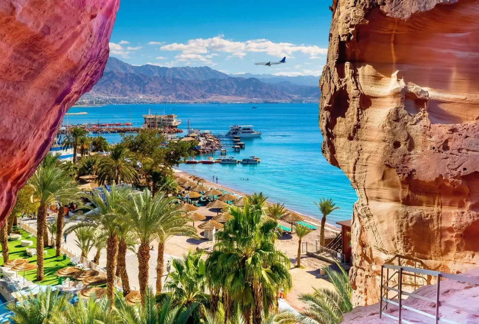 Aqaba and A panoramic view from a rocky outcrop surrounded by vast ocean waters under a clear blue sky in our Jordan itinerary 10 days