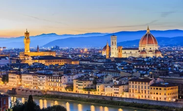 A picturesque view of Florence at dusk, showcasing the city's iconic skyline illuminated by the fading light in our Italy itnerary 10 Days