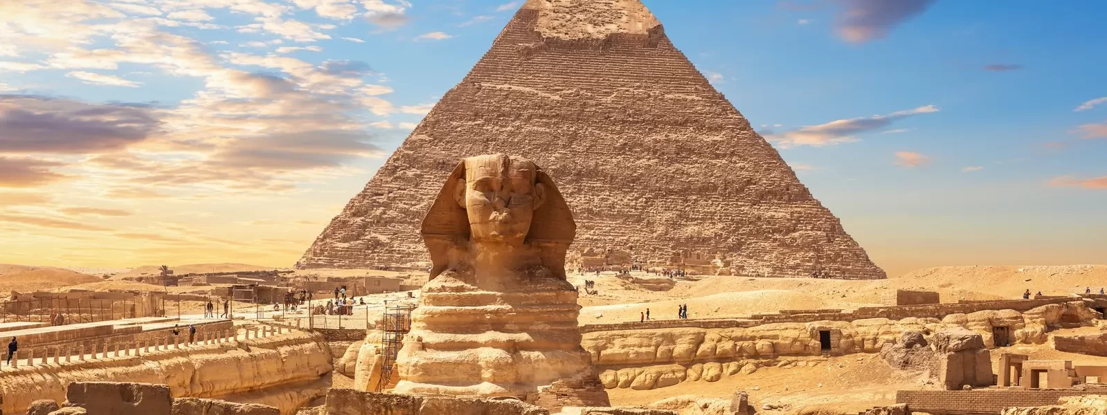 The Great Sphinx and the Pyramid of Giza silhouetted against a vibrant sunset sky with our Egypt itinerary 8 days