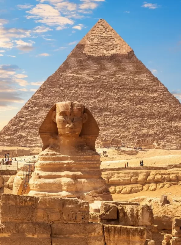The Great Sphinx and the Pyramid of Giza silhouetted against a vibrant sunset sky with our Egypt itinerary 8 days