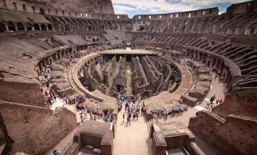 The Colosseum in Rome, Italy, showcasing its ancient architecture and grandeur against a clear blue sky in our Italy itinerary days