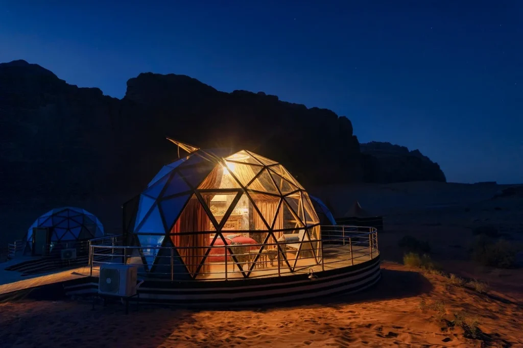 Jordan 8-Day Luxury Private Tour 16 Glass panoramic dome suite lit up at night at Memories Aicha Luxury Camp, Wadi Rum, Jordan