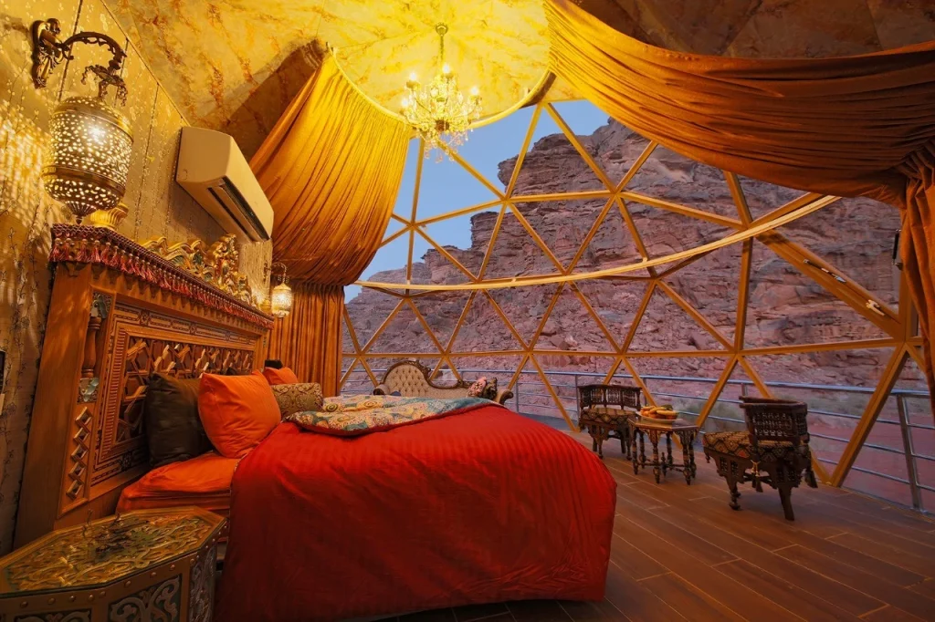 Jordan 8-Day Luxury Private Tour 8 Inside a panoramic luxury suite with a king bed and glass walls facing the sandstone cliffs, Memories Aicha Luxury Camp, Wadi Rum