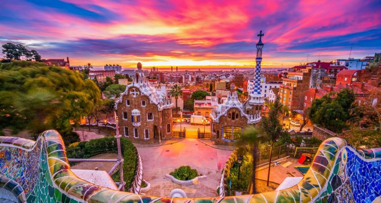 Beautiful sunrise in Barcelona seen from Park Guell. Park was built from 1900 to 1914 and was officially opened as a public park in 1926. In 1984, UNESCO declared the park a World Heritage Site